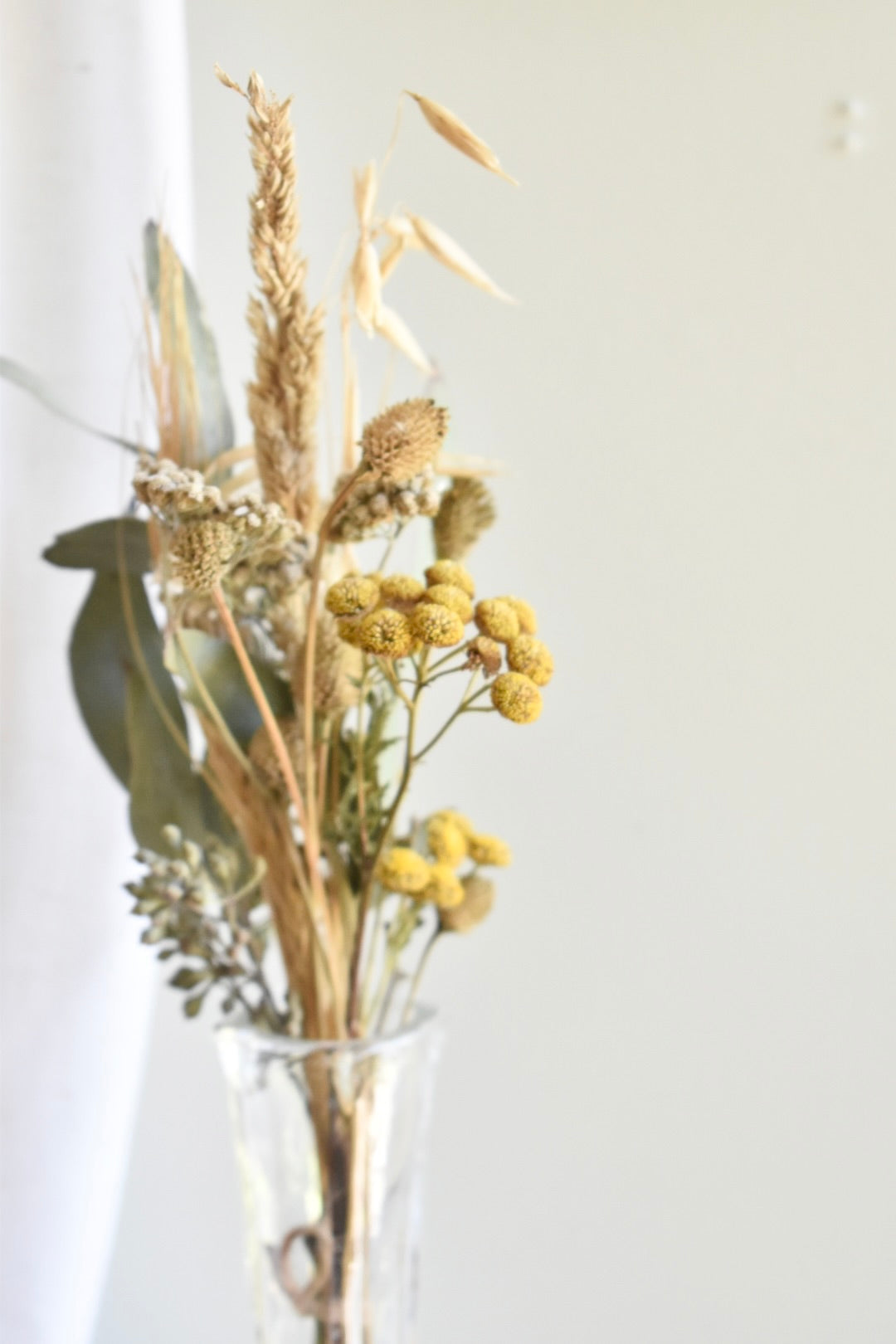 glass bud vase with dried flowers